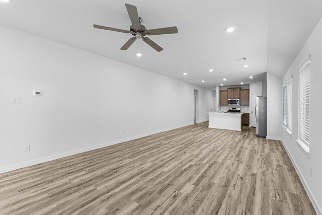 unfurnished living room featuring light wood-type flooring, visible vents, a ceiling fan, recessed lighting, and baseboards