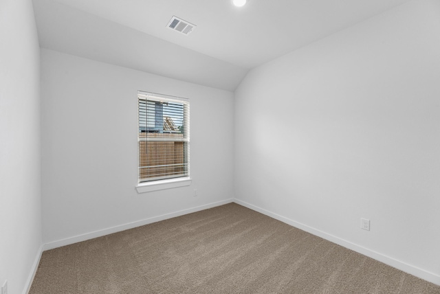 unfurnished room featuring lofted ceiling, carpet flooring, baseboards, and visible vents