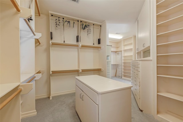 spacious closet featuring visible vents and light colored carpet