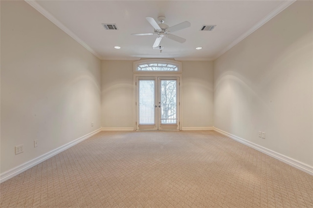 unfurnished room with visible vents, baseboards, and ornamental molding