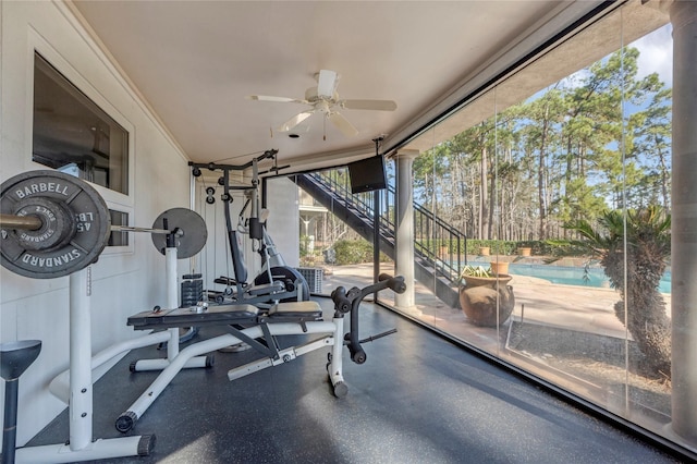 exercise room with a wall of windows and a ceiling fan