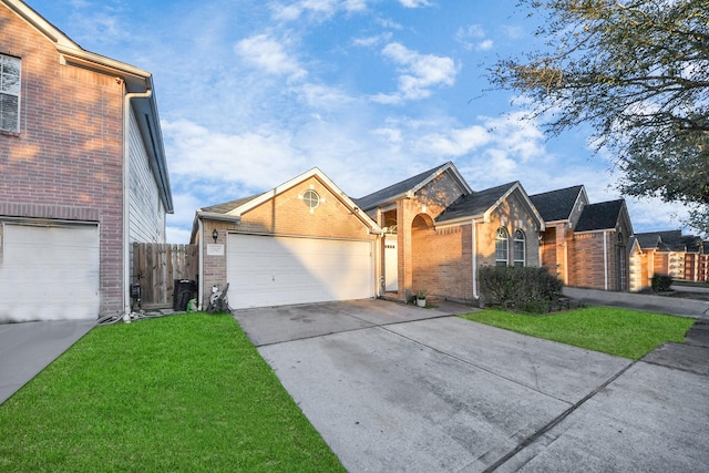 ranch-style house with a front yard, brick siding, driveway, and fence