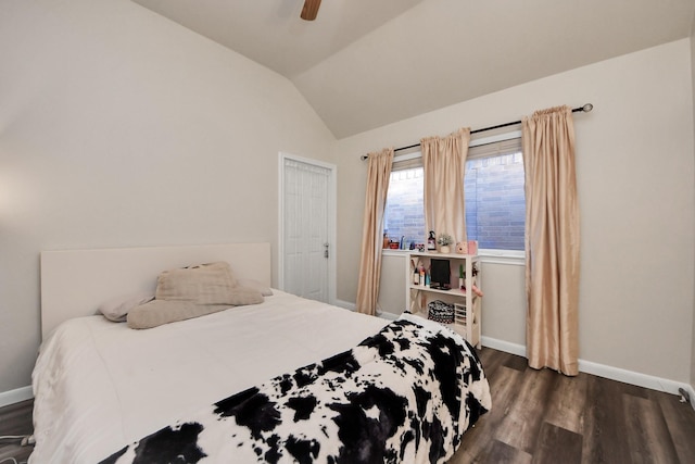 bedroom with dark wood finished floors, lofted ceiling, baseboards, and ceiling fan