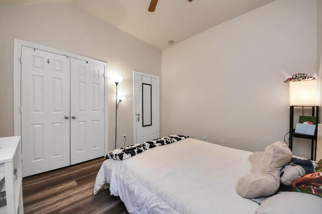 bedroom with lofted ceiling, a ceiling fan, dark wood-style flooring, and a closet