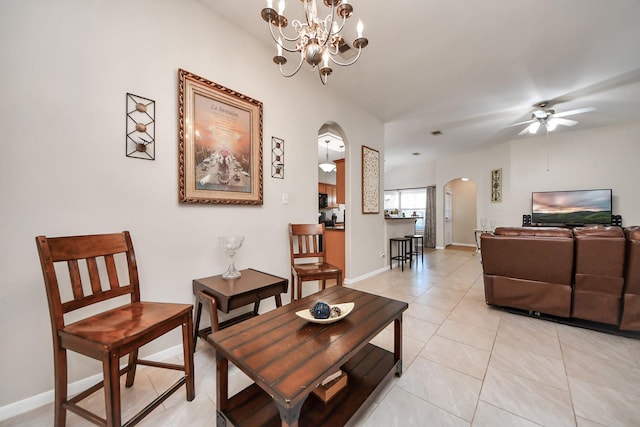 living room with light tile patterned floors, baseboards, arched walkways, and ceiling fan with notable chandelier