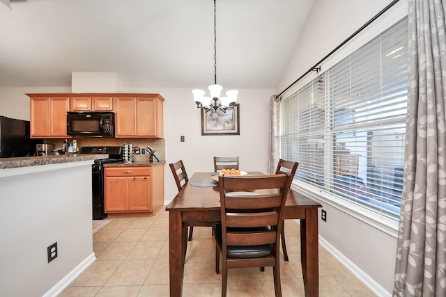 dining space with light tile patterned floors, baseboards, a notable chandelier, and vaulted ceiling