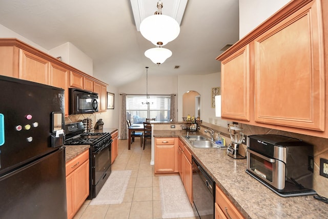 kitchen featuring light tile patterned floors, a peninsula, a sink, black appliances, and tasteful backsplash