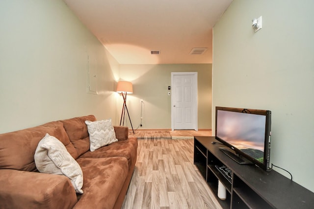 living area with visible vents, baseboards, and light wood-style flooring