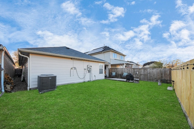 back of house featuring a patio, central air condition unit, a yard, and a fenced backyard