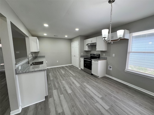 kitchen with wood finished floors, baseboards, stainless steel electric range, a sink, and under cabinet range hood