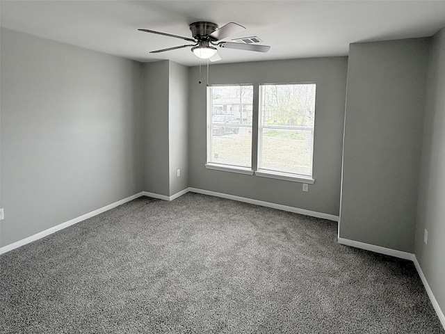 unfurnished room with visible vents, baseboards, carpet floors, and ceiling fan