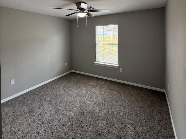 spare room featuring ceiling fan, baseboards, and carpet floors