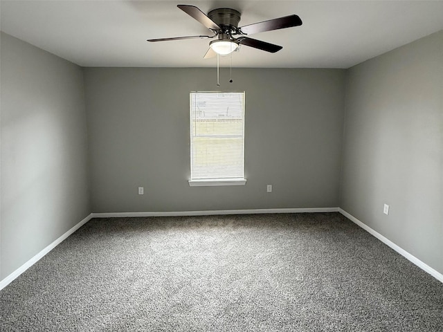 carpeted empty room featuring baseboards and ceiling fan