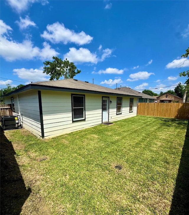 5422 Tommye St, Houston, TX 77028 - back of property with fence, a lawn, and central AC