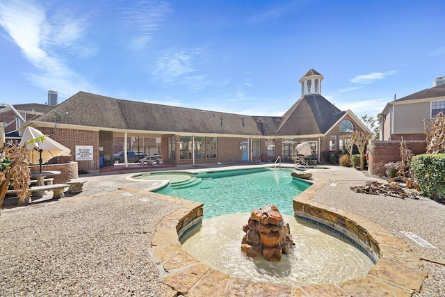 community pool with fence and a patio area