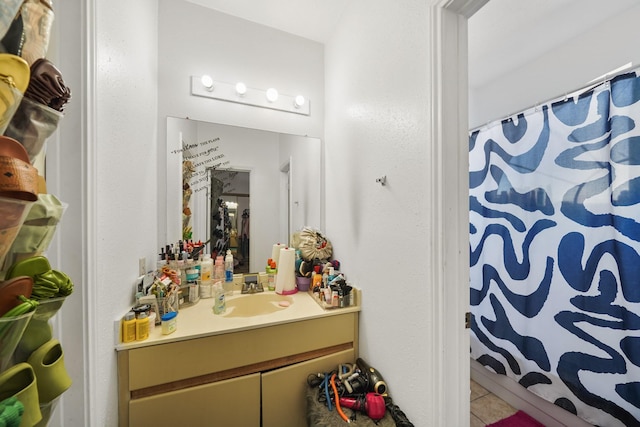 full bath with tile patterned floors, curtained shower, and vanity