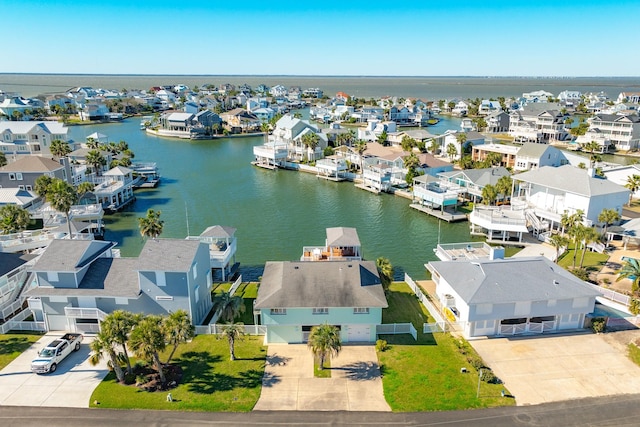 drone / aerial view with a residential view and a water view