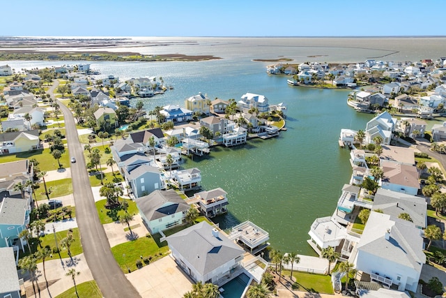 drone / aerial view featuring a residential view and a water view