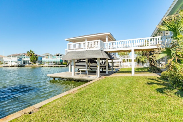 dock area with a yard, a water view, and boat lift