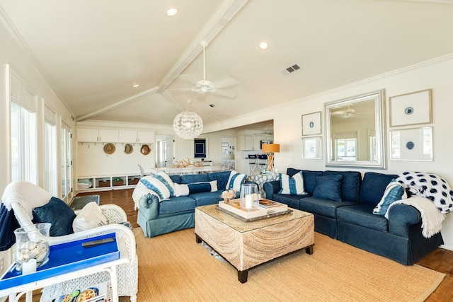 living area featuring a ceiling fan, wood finished floors, visible vents, vaulted ceiling with beams, and crown molding