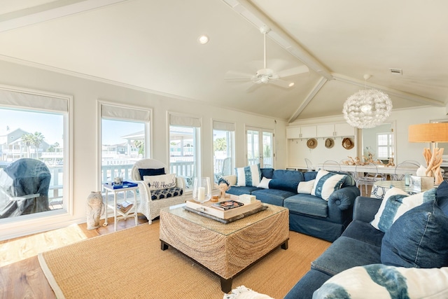 living room featuring a wealth of natural light, wood finished floors, vaulted ceiling with beams, and ceiling fan