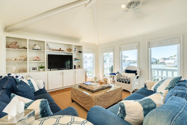 living room with beam ceiling, light wood-style floors, ornamental molding, and a ceiling fan