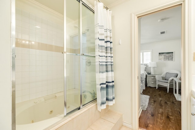 full bath with visible vents, a combined bath / shower with jetted tub, ornamental molding, ensuite bathroom, and wood finished floors