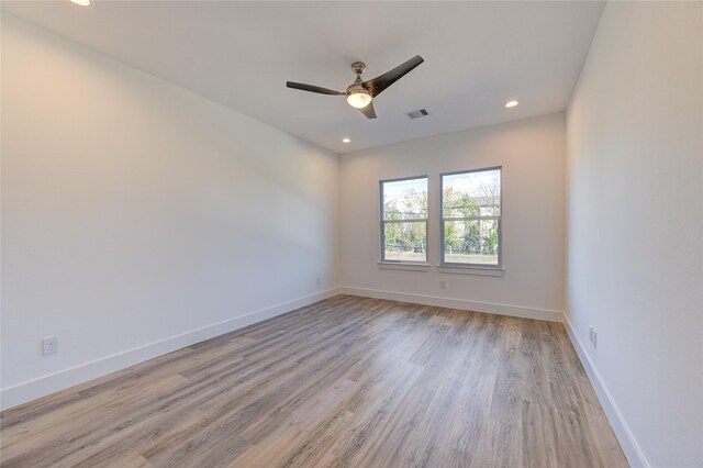 unfurnished room featuring recessed lighting, visible vents, baseboards, and wood finished floors