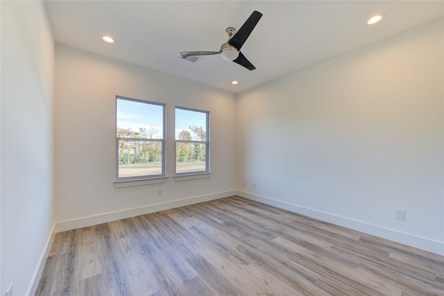 empty room with recessed lighting, baseboards, and light wood-type flooring