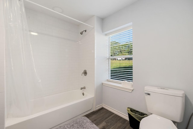 bathroom with toilet, shower / bath combo with shower curtain, baseboards, and wood finished floors