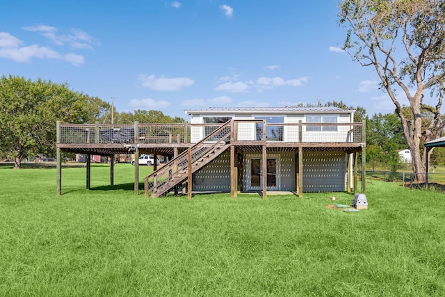 rear view of property with a wooden deck, a lawn, metal roof, and stairs