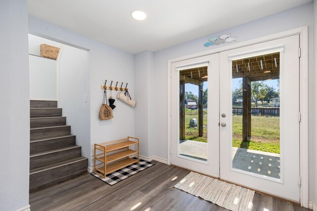 doorway to outside featuring french doors, baseboards, wood finished floors, and stairway