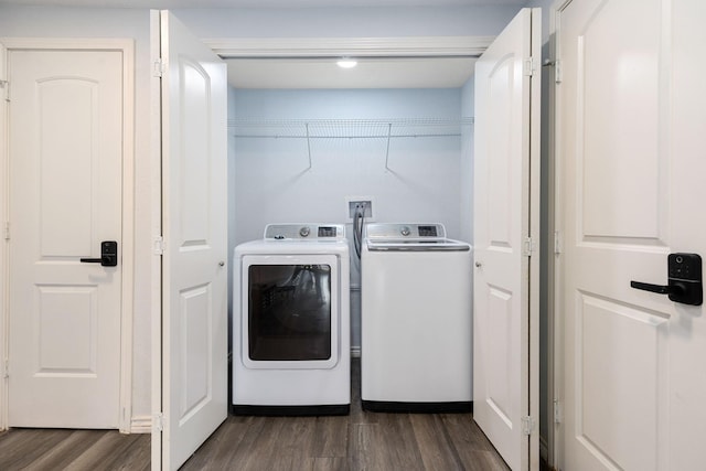 clothes washing area with laundry area, independent washer and dryer, and dark wood-type flooring