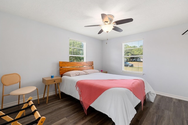 bedroom with a ceiling fan, baseboards, and wood finished floors