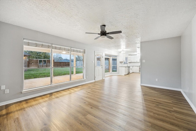 unfurnished living room featuring baseboards, ceiling fan, and wood finished floors