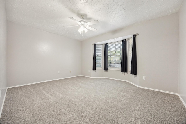 carpeted empty room featuring baseboards, a textured ceiling, and ceiling fan