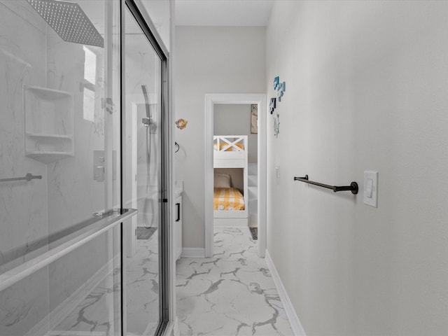 bathroom featuring a marble finish shower, baseboards, and marble finish floor