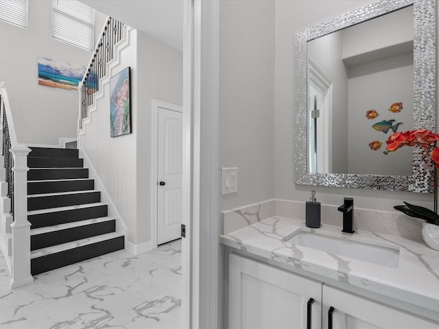 bathroom featuring marble finish floor and vanity