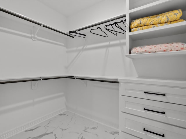 walk in closet with marble finish floor