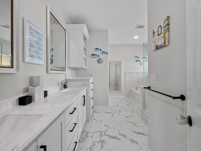 bathroom featuring visible vents, double vanity, a sink, marble finish floor, and a shower with door