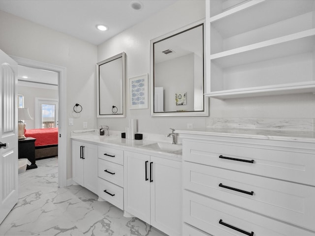 ensuite bathroom with visible vents, double vanity, a sink, marble finish floor, and connected bathroom