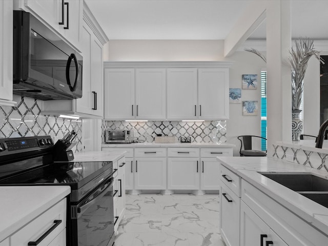 1018 Seashell Dr, Surfside Beach, TX 77541 - kitchen featuring black appliances, decorative backsplash, white cabinetry, light marble finish flooring, and light stone countertops