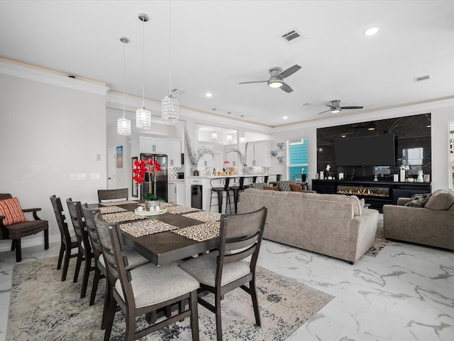 dining room featuring visible vents, marble finish floor, and ornamental molding