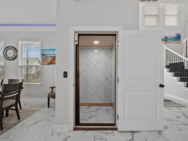 interior space with recessed lighting, baseboards, and ornamental molding