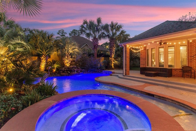 view of swimming pool with an in ground hot tub, a patio area, and a fenced in pool