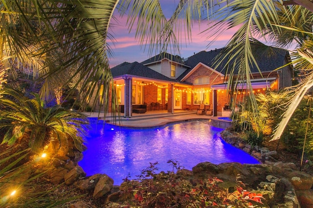 view of swimming pool featuring a patio and a pool with connected hot tub