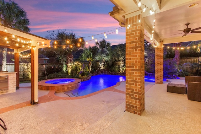 view of swimming pool with a fenced backyard, a pool with connected hot tub, ceiling fan, and a patio area