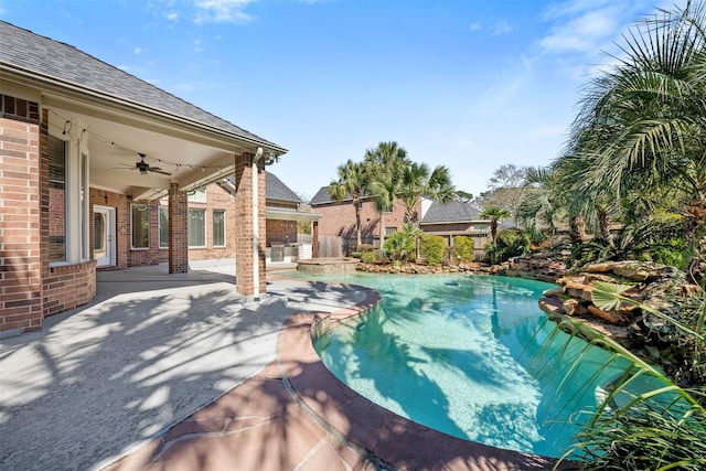 outdoor pool featuring a patio area, a ceiling fan, and fence