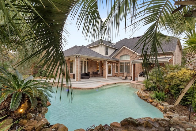 view of swimming pool featuring a pool with connected hot tub, ceiling fan, and a patio area