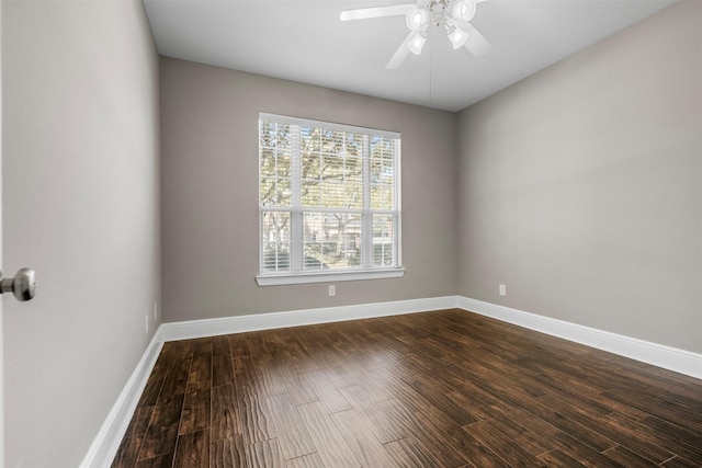 empty room featuring ceiling fan, baseboards, and dark wood-style flooring